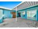 Back patio featuring an outdoor entertaining space with a covered structure and exterior sliding doors at 10026 W Lancaster Dr, Sun City, AZ 85351