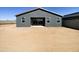 Rear exterior view showcases modern design, ample windows and sliding doors, complemented by a spacious backyard at 46963 W Coe St, Maricopa, AZ 85139