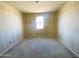 Bedroom with a window and smooth walls, ready for a personal touch at 46963 W Coe St, Maricopa, AZ 85139