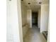 Hallway leading to the walk-in closet featuring newly plastered walls and ceiling at 46963 W Coe St, Maricopa, AZ 85139