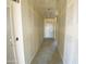 Hallway featuring smooth walls and a view of a white door at the end at 46963 W Coe St, Maricopa, AZ 85139