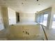 Open-concept living room showcasing smooth walls and expansive windows for natural lighting at 46963 W Coe St, Maricopa, AZ 85139
