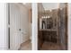 Bathroom with decorative tile shower stall, toilet, and sink in separate room at 1926 E Siesta Ln, Phoenix, AZ 85024