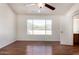 Large bedroom with hardwood floors, ceiling fan and a beautiful window view at 1926 E Siesta Ln, Phoenix, AZ 85024