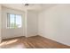 This bedroom features wood-style floors, a ceiling fan, and a window with a view at 1926 E Siesta Ln, Phoenix, AZ 85024
