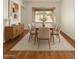 Dining room with hardwood floors, large windows, and seating for six at 1926 E Siesta Ln, Phoenix, AZ 85024