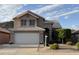Charming two-story home with a well-manicured front yard and a two-car garage in a suburban neighborhood at 1926 E Siesta Ln, Phoenix, AZ 85024
