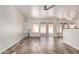 Bright living area with tile floors, ceiling fan, and sliding door to patio at 1926 E Siesta Ln, Phoenix, AZ 85024