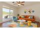 Modern living room with a vibrant color scheme and sliding glass door access at 1926 E Siesta Ln, Phoenix, AZ 85024