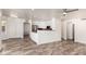 Open floor plan with living and kitchen area with tile floors and white cabinets at 1926 E Siesta Ln, Phoenix, AZ 85024