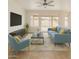 Cozy living room with comfortable blue furnishings and sliding glass doors at 1926 E Siesta Ln, Phoenix, AZ 85024