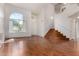 Bright living room features a staircase, a large window, and wood flooring at 1926 E Siesta Ln, Phoenix, AZ 85024