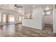 Open living space with ceramic tile floors, ceiling fan, and a breakfast bar to the kitchen at 1926 E Siesta Ln, Phoenix, AZ 85024