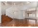 Open-concept living room with staircase, hardwood floors, and high ceilings exudes contemporary elegance at 1926 E Siesta Ln, Phoenix, AZ 85024