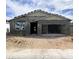 New home construction with a stucco facade, open garage, and modern roof tiling at 46923 W Old Timer Rd, Maricopa, AZ 85139