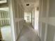Bright hallway with fresh drywall, offering a glimpse of natural light at the far end at 46923 W Old Timer Rd, Maricopa, AZ 85139