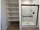 Bathroom with walk-in closet with shelving and modern walk-in shower at 46963 W Coe St, Maricopa, AZ 85139