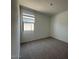 Comfortable bedroom features carpeted floor, window with bright view, and neutral walls at 46963 W Coe St, Maricopa, AZ 85139