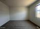 Bright bedroom features soft carpet, and a window providing natural light at 46963 W Coe St, Maricopa, AZ 85139