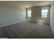 Spacious bedroom featuring plush carpeting and dual windows for ample natural light at 46963 W Coe St, Maricopa, AZ 85139