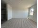 Bright bedroom with a window, plush carpeting, and adjacent bathroom with glass shower doors at 46963 W Coe St, Maricopa, AZ 85139