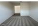 Carpeted bedroom featuring neutral walls and ample space at 46963 W Coe St, Maricopa, AZ 85139