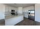 Modern kitchen features an island, stainless steel appliances, and quartz countertops at 46963 W Coe St, Maricopa, AZ 85139