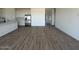 Bright, open living space with tile flooring and a kitchen with stainless steel appliances at 46963 W Coe St, Maricopa, AZ 85139