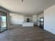 Open-concept living area features tile flooring and a modern kitchen with stainless appliances at 46963 W Coe St, Maricopa, AZ 85139