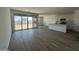 Open-concept living area features tile flooring, sliding glass doors, and a bright kitchen at 46963 W Coe St, Maricopa, AZ 85139