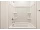 Clean bathroom featuring a shower and bath combo with wall shelving at 4994 W Hunter Trl, San Tan Valley, AZ 85144