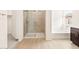 Bright bathroom featuring a shower with glass doors, bathtub, and dual sinks at 4994 W Hunter Trl, San Tan Valley, AZ 85144