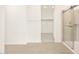 Bathroom featuring a shower with glass doors and open walk-in closet at 4994 W Hunter Trl, San Tan Valley, AZ 85144