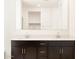 Bright bathroom with dual sinks, quartz countertop and white framed mirror at 4994 W Hunter Trl, San Tan Valley, AZ 85144