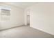 Bright, carpeted bedroom with large window and closet at 4994 W Hunter Trl, San Tan Valley, AZ 85144