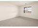 Bright bedroom with neutral carpet, window with blinds, and white walls at 4994 W Hunter Trl, San Tan Valley, AZ 85144