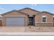 Charming single-story home showcasing a neutral color scheme, a gray garage door, and a low maintenance front yard at 4994 W Hunter Trl, San Tan Valley, AZ 85144