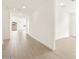 Hallway with hardwood floors leading to an open living space and backyard access at 4994 W Hunter Trl, San Tan Valley, AZ 85144