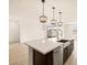 Open kitchen island featuring a stainless steel dishwasher, sink and sliding glass door with access to the backyard at 4994 W Hunter Trl, San Tan Valley, AZ 85144