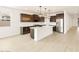 Modern kitchen with stainless steel appliances, dark wood cabinets, and white countertop island at 4994 W Hunter Trl, San Tan Valley, AZ 85144