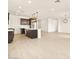 An open kitchen features a center island, stainless steel appliances, and modern lighting at 4994 W Hunter Trl, San Tan Valley, AZ 85144