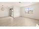Bright living area with tile flooring, patio door, and modern lighting at 4994 W Hunter Trl, San Tan Valley, AZ 85144