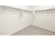 A bright and airy walk-in closet with ample shelving and neutral carpet at 4994 W Hunter Trl, San Tan Valley, AZ 85144