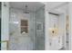 Modern bathroom featuring a glass enclosed shower with elegant gray marble and designer tiled niche at 8675 E Thoroughbred Trl, Scottsdale, AZ 85258