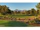 Scenic golf course with lush greens and mountain views in the background at 8675 E Thoroughbred Trl, Scottsdale, AZ 85258