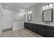 Modern bathroom with double vanity, white marble tile shower, and elegant fixtures at 32513 N 135Th Dr, Peoria, AZ 85383