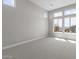 Bright bedroom featuring carpet flooring and large windows with scenic backyard views at 32513 N 135Th Dr, Peoria, AZ 85383