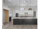Modern kitchen features quartz countertops, stainless appliances, and ample cabinet space at 32513 N 135Th Dr, Peoria, AZ 85383