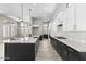 Spacious kitchen featuring white cabinets, black island, and quartz countertops at 32513 N 135Th Dr, Peoria, AZ 85383