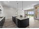Stylish kitchen with a large island, quartz countertop, and stainless steel appliances at 32513 N 135Th Dr, Peoria, AZ 85383